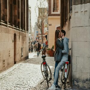 Couple kissing in a historic European street, one of the best romantic places in Europe for Valentine’s Day.